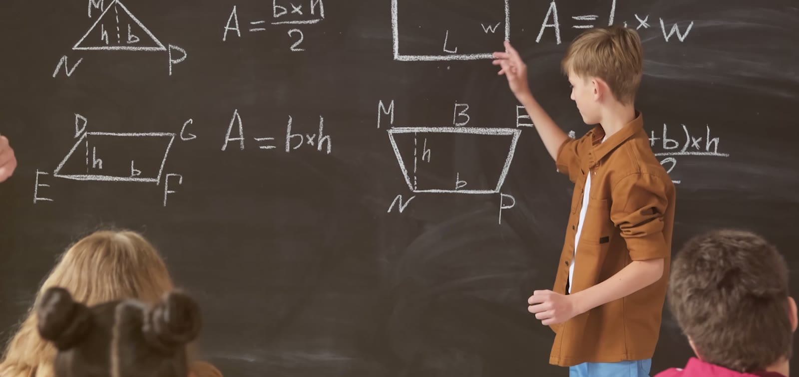 A student working at the board while classmates watch