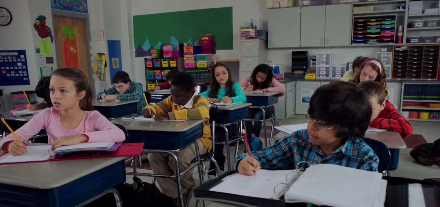 A student annotating a text with a pencil
