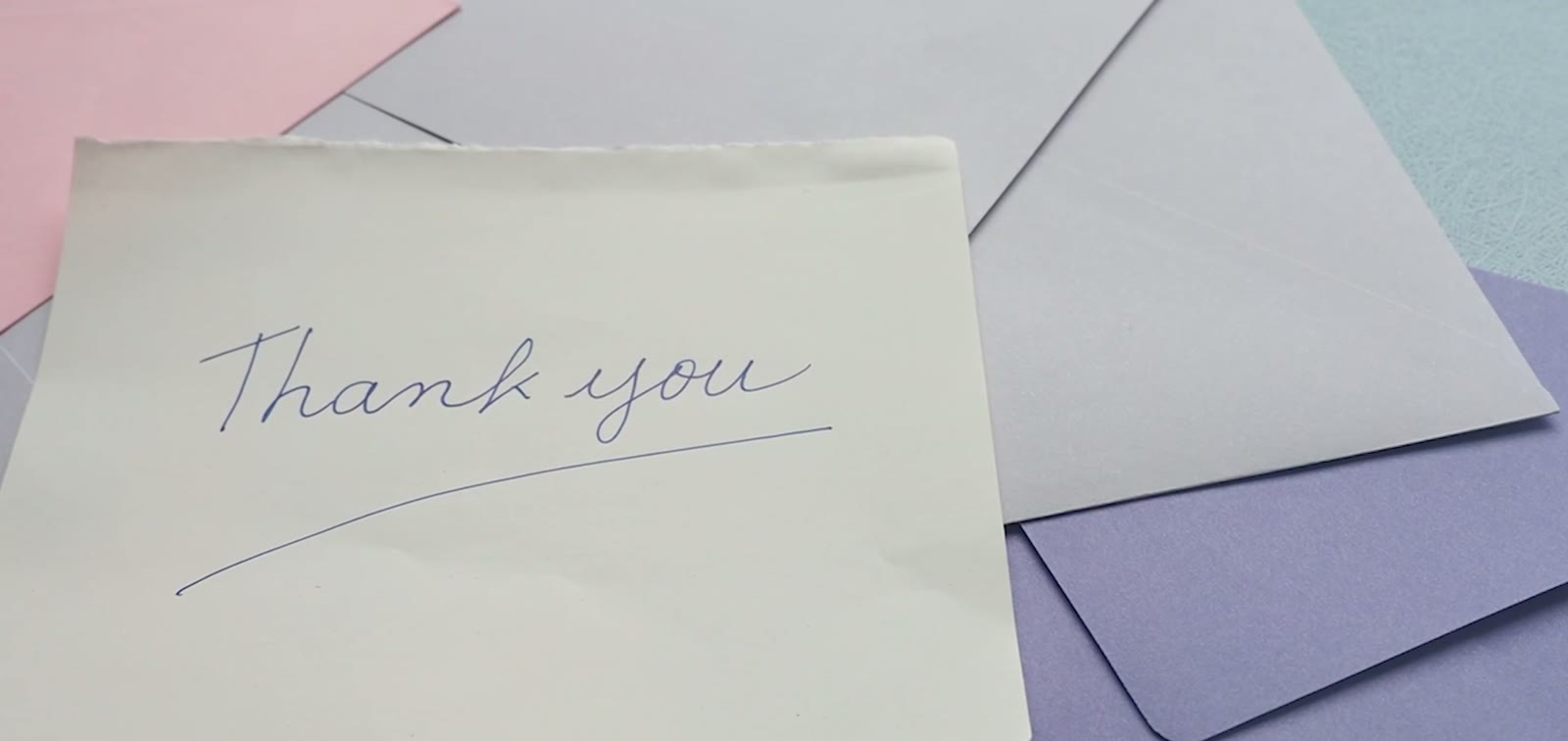A handwritten thank you note left on a desk